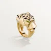 Anello Panthere De Cartier – Oro giallo, lacca, granato tsavorite, onice – Cartier