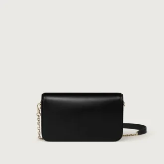 Borsa a catena mini, Double C De Cartier – Pelle di vitello nera, finitura in oro e smalto nero – Cartier